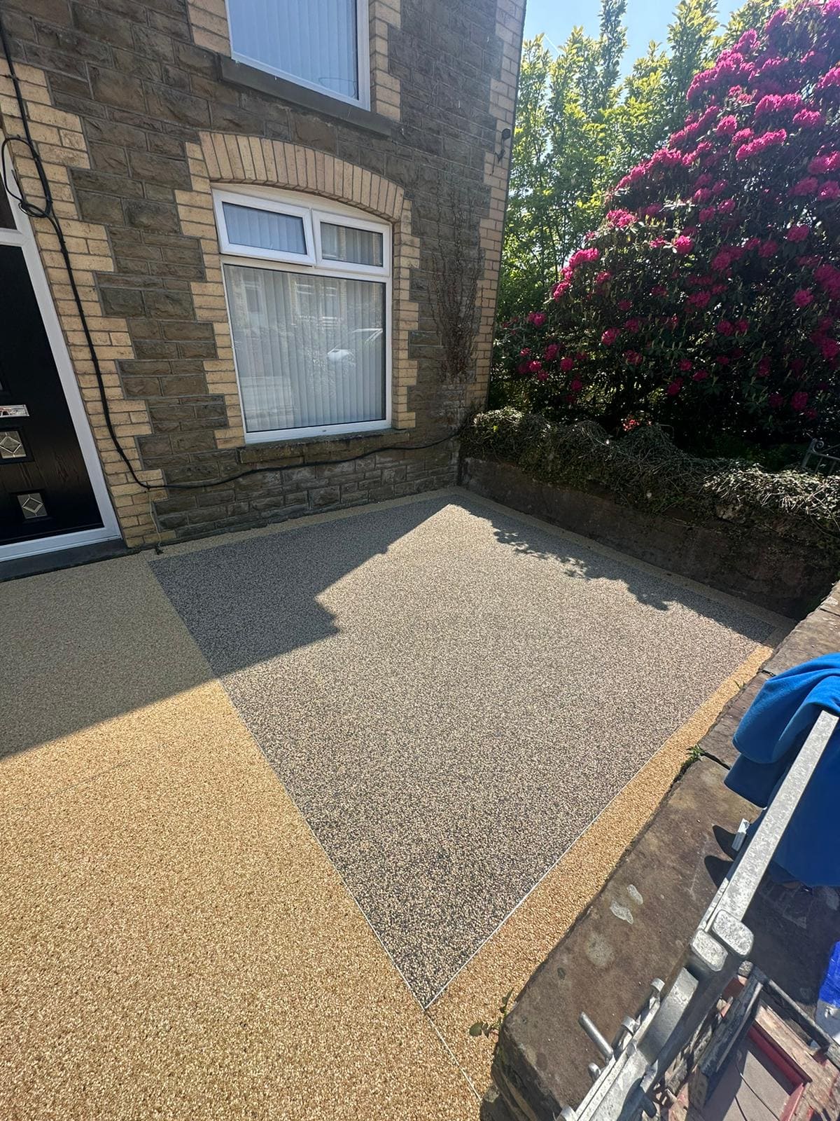 Left angled view of new resin bound solution laid in front garden of property in ystalyfera using high quality Vuba products
